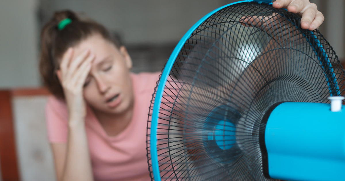 A woman sitting in front of a fan