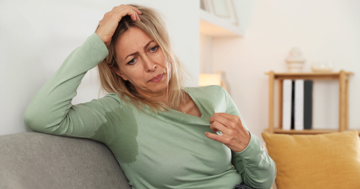 Woman, fanning herself, sweating 