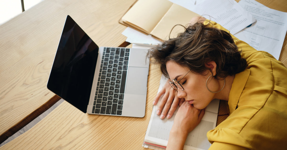 lady lying on her arms at her desk