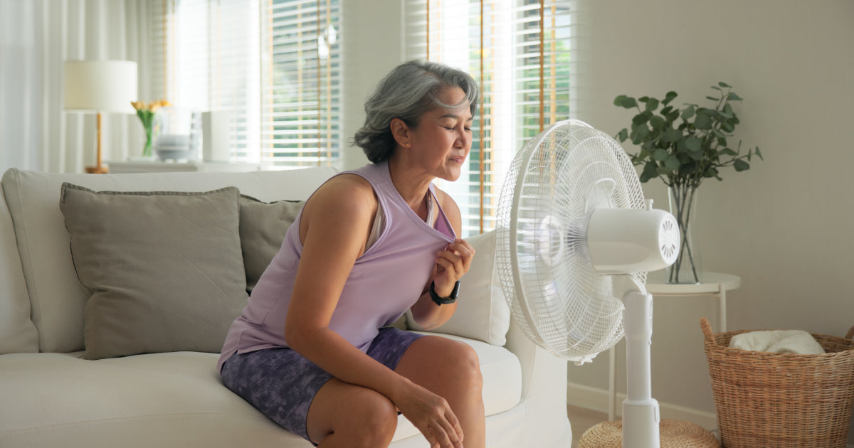 A woman sitting in front of a fan